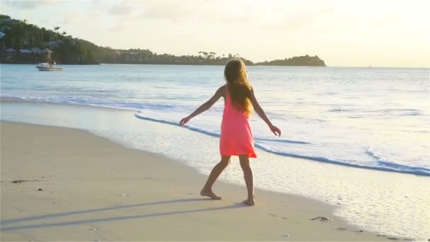 Schattig meisje veel plezier op tropisch strand tijdens vakantie. Slow Motion — Stockvideo