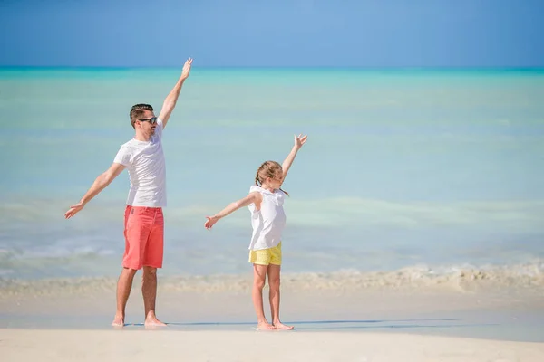 Niña y papá feliz divirtiéndose durante las vacaciones en la playa — Foto de Stock