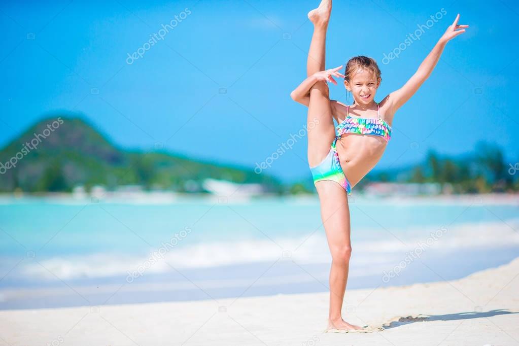 Beautiful little girl on beach having fun. Happy girl enjoy summer vacation background the blue sky and turquoise water in the sea on caribbean island