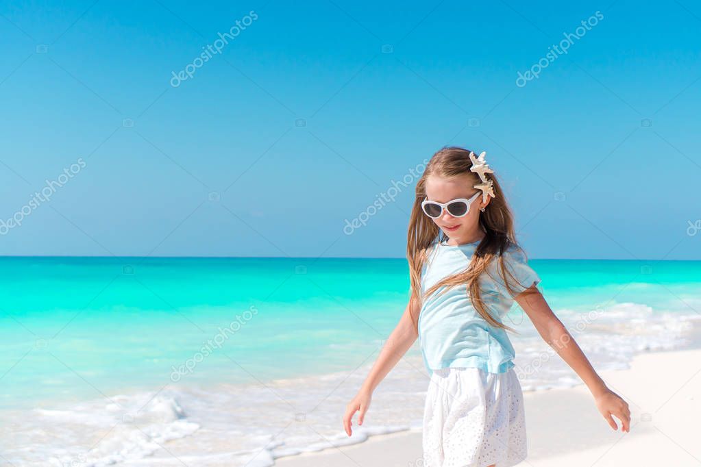 Adorable little girl on tropical beach