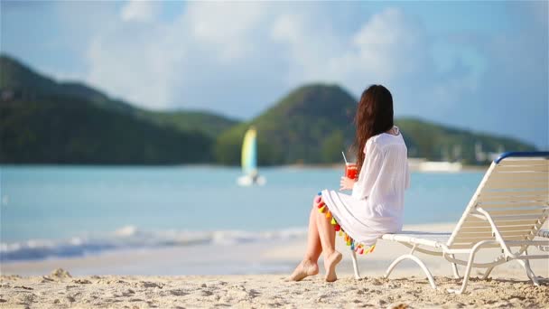 Mujer joven con sabroso cóctel en la playa blanca — Vídeos de Stock