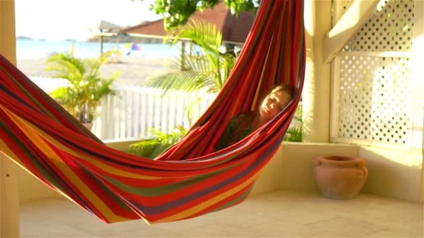 Adorable little girl on tropical vacation relaxing in hammock — Stock Video