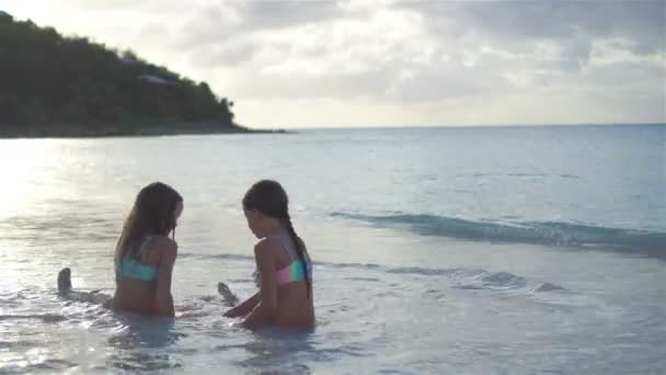 Adorable little girls relaxing on the beach — Stock Video