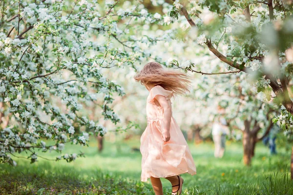 Menina bonito em flor macieira jardim desfrutar do dia quente — Fotografia de Stock