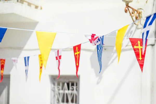 Street with colorful flags in Mykonos, Greece — Stock Photo, Image