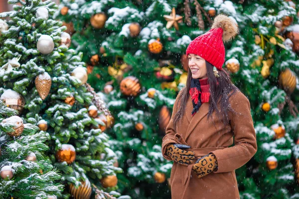 Happy girl near fir-tree branch in snow for new year. — Stock Photo, Image