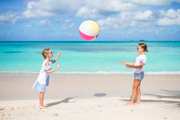 Little adorable girls playing with ball on the beach. Kids having fun on the seashore — Stock Photo, Image