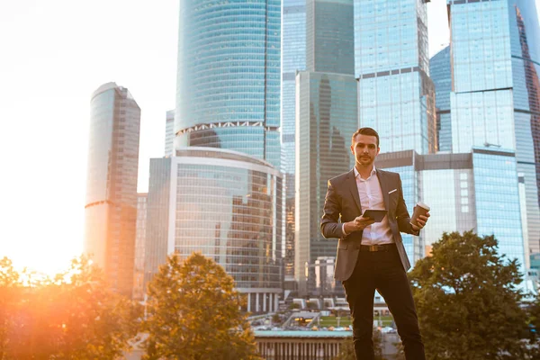 Podnikatel při pohledu na kopírování prostoru, zatímco stojí proti skleněnému mrakodrapu — Stock fotografie