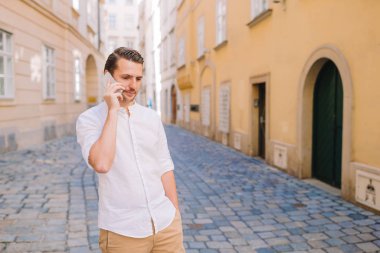 Genç adam eski Avrupa şehrinin özçekimini yapıyor.