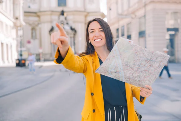 Mujer joven con un mapa de la ciudad. Viajar chica turística con mapa en Viena al aire libre durante las vacaciones en Europa . — Foto de Stock