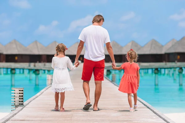 Happy beautiful family of dad and kids on white beach — Stock Photo, Image