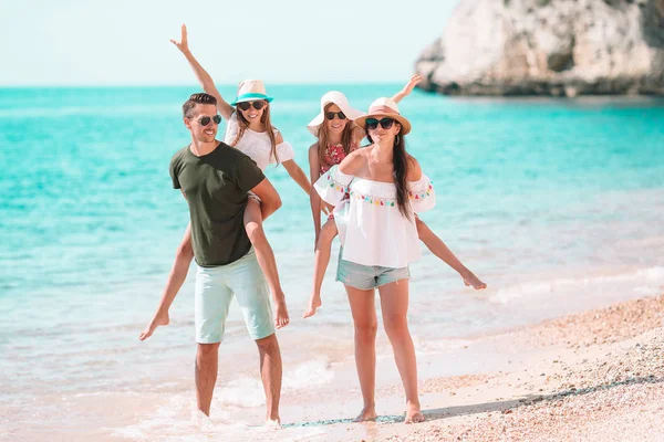 Happy beautiful family with kids on the beach — Stock Photo, Image