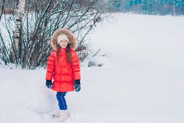 Portrait of little adorable girl in snow sunny winter day — Stock Photo, Image