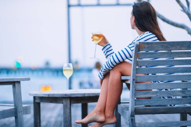 akşam açık kafe, beyaz şarap ile genç kız.