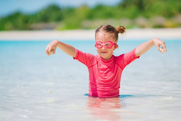Malá rozkošná dívka hraje na pláži s míčem — Stock fotografie