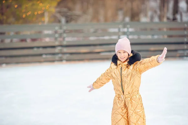 Entzückendes kleines Mädchen beim Schlittschuhlaufen auf der Eisbahn — Stockfoto