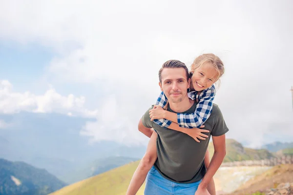 Beautiful happy family in mountains in the background of fog — Stock Photo, Image