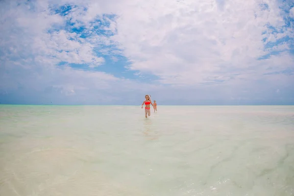 Kids have a lot of fun at tropical beach playing together Stock Picture