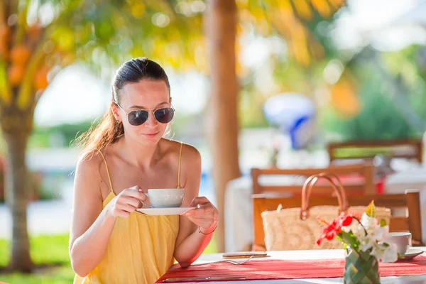 Frau trinkt heißen Kaffee auf Luxus-Hotelterrasse mit Meerblick im Resort-Restaurant. — Stockfoto