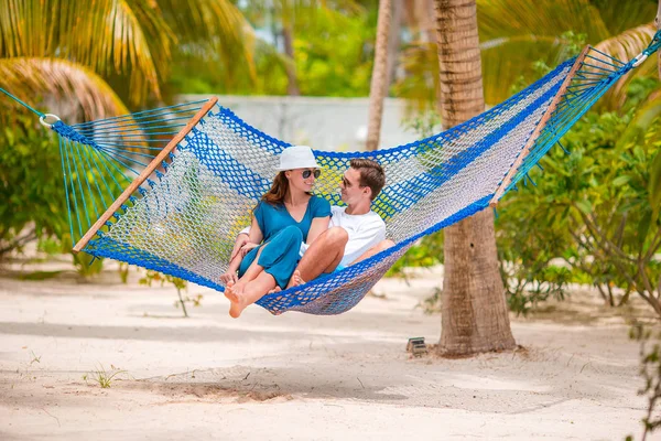 Family on summer vacation relaxing in hammock Stock Picture