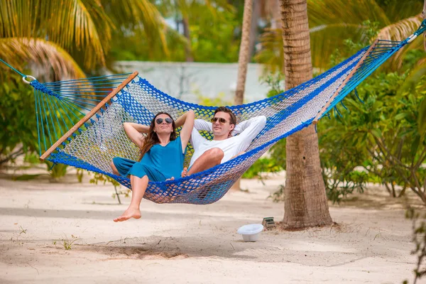 Family on summer vacation relaxing in hammock Stock Picture