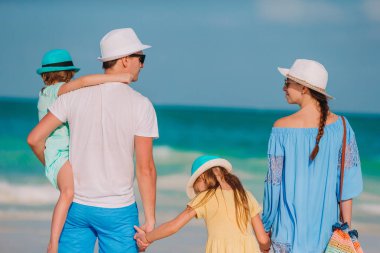 Yaz tatili boyunca sahilde mutlu bir aile.