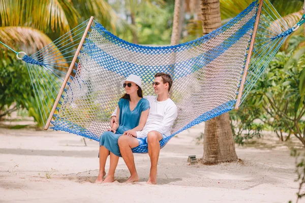 Family on summer vacation relaxing in hammock — Stock Photo, Image