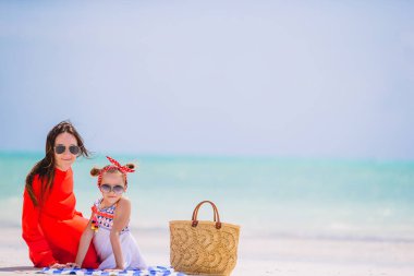 Güzel anne ve kız sahilde yaz tatilinin tadını çıkarıyorlar..