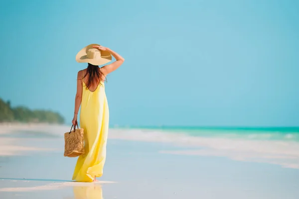 Νεαρή όμορφη γυναίκα διασκεδάζει στην τροπική ακτή. Ευτυχισμένο κορίτσι φόντο το γαλάζιο του ουρανού και γαλαζοπράσινα νερά στη θάλασσα στην Καραϊβική νησί — Φωτογραφία Αρχείου