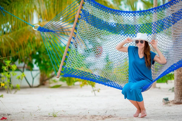 Adorable girl on tropical vacation relaxing in hammock — Stock Photo, Image