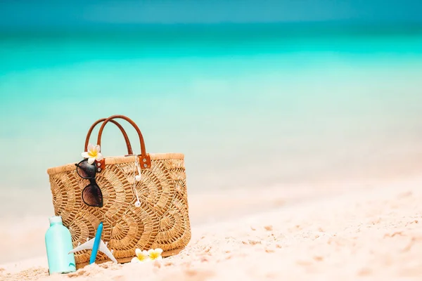 Accesorios de playa - bolsa de paja, sombrero y anteojos en la playa —  Fotos de Stock