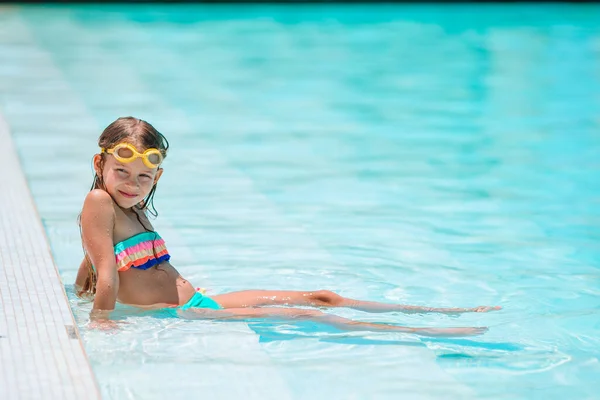 Schattig klein meisje zwemmen bij het buitenzwembad — Stockfoto