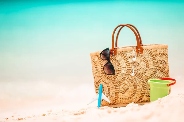 Accesorios de playa - bolsa de paja, sombrero y anteojos en la playa —  Fotos de Stock