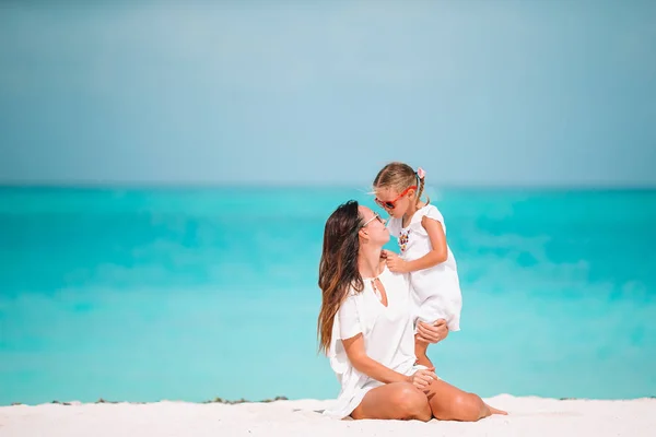 Mooie moeder en dochter aan het strand genieten van zomervakantie. — Stockfoto