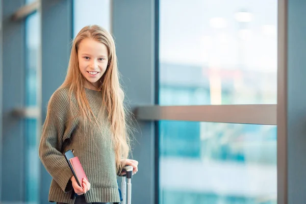 Schattig klein meisje op de luchthaven in grote internationale luchthaven in de buurt van venster — Stockfoto