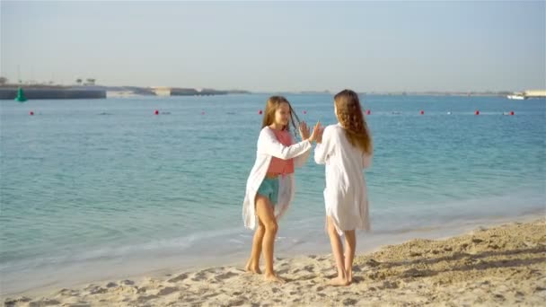 재미있는 작은 소녀들은 함께 노는 열대 해변에서 재미를 즐긴다. — 비디오