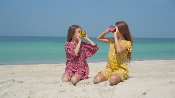 Twee kleine gelukkige meisjes hebben veel plezier op tropische strand spelen samen — Stockvideo