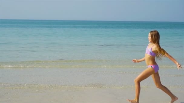 Rozkošná aktivní holčička na pláži během letních prázdnin — Stock video