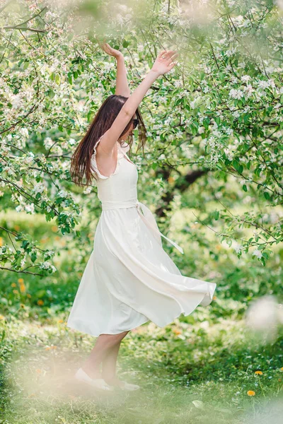 Schöne Frau genießt Duft im Frühlingskirschgarten — Stockfoto