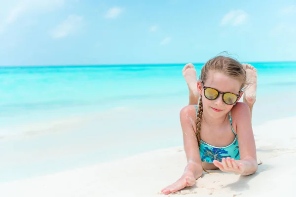 Счастливая маленькая девочка веселится на пляже — стоковое фото