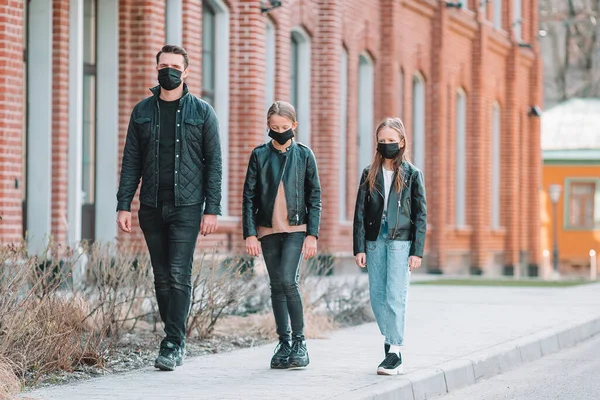 People wearing a mask on a background of a modern building,