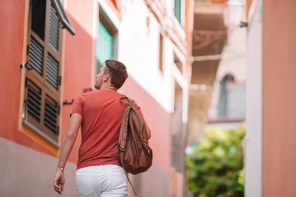 Young man background the old european city — Stock Photo, Image