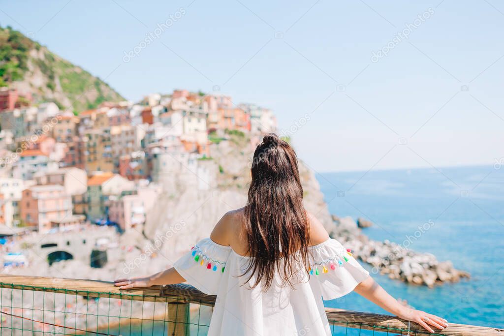 Tourist looking at scenic view of Manarola, Cinque Terre, Liguria, Italy