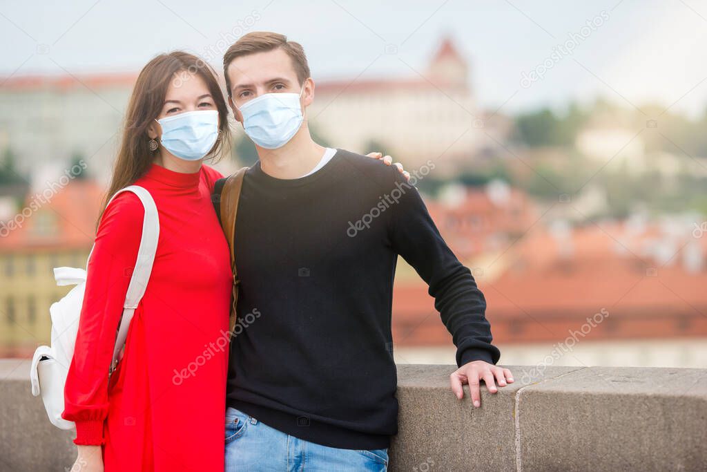 Happy tourist couple traveling on Charles Bridge in Prague