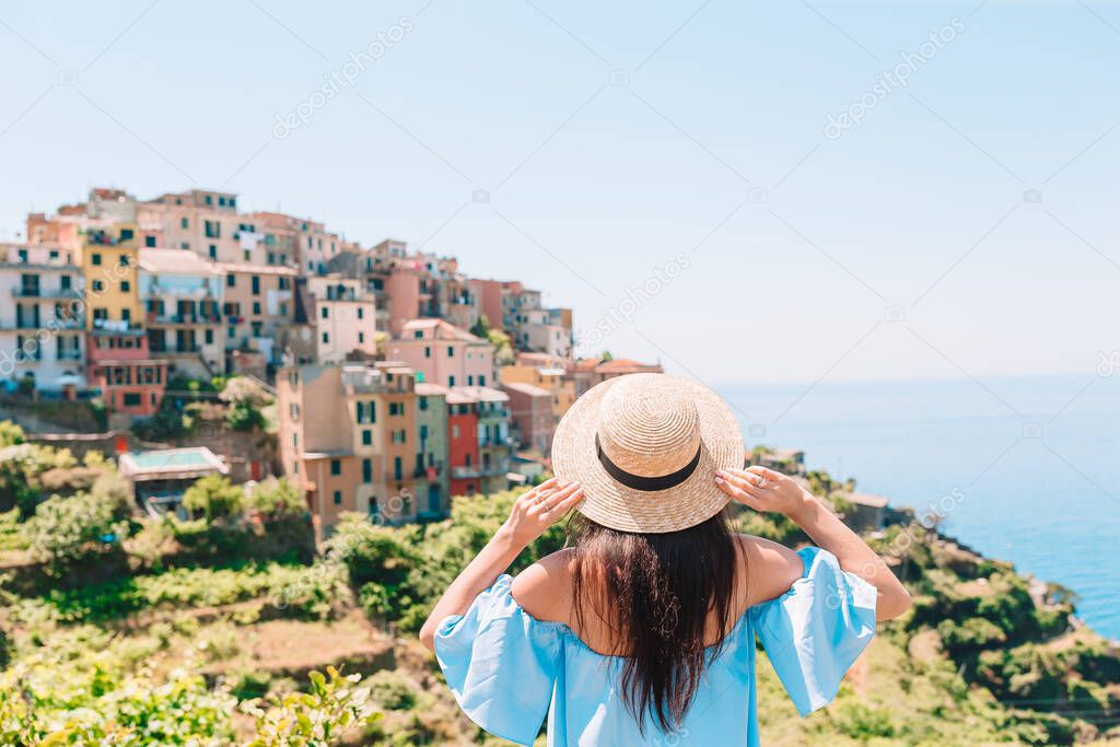 Tourist looking at scenic view of Manarola, Cinque Terre, Liguria, Italy