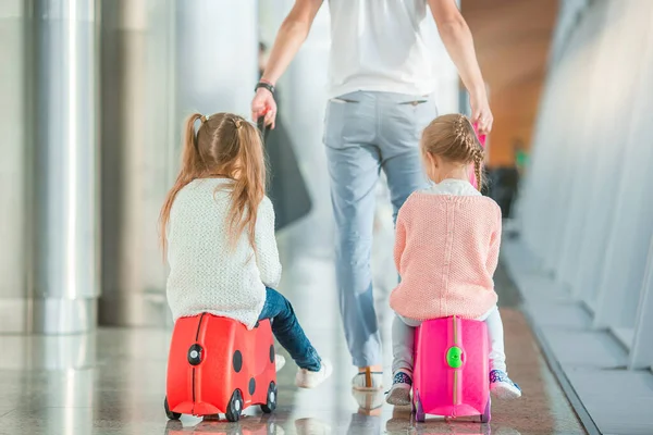 Happy family with two kids in airport have fun waiting for boarding — Stock Photo, Image