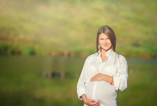 Zwangere vrouw in openlucht park, warm weer — Stockfoto