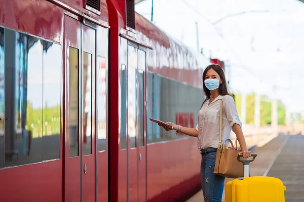 Νεαρή τουρίστρια με αποσκευές στην πλατφόρμα που περιμένει το τρένο — Φωτογραφία Αρχείου