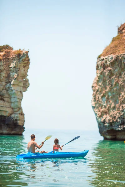 Sporty attractive family kayaking on sea together — Stock Photo, Image