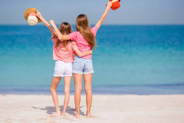 Μικρά χαρούμενα αστεία κορίτσια διασκεδάζουν πολύ στην τροπική παραλία παίζοντας μαζί.. — Φωτογραφία Αρχείου